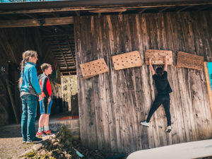 students climbing on a bouldering wall