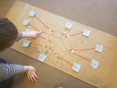 middle schooler looking at map