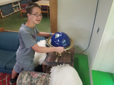 middle schooler placing globe on table
