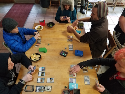 middle schoolers and teacher playing card games